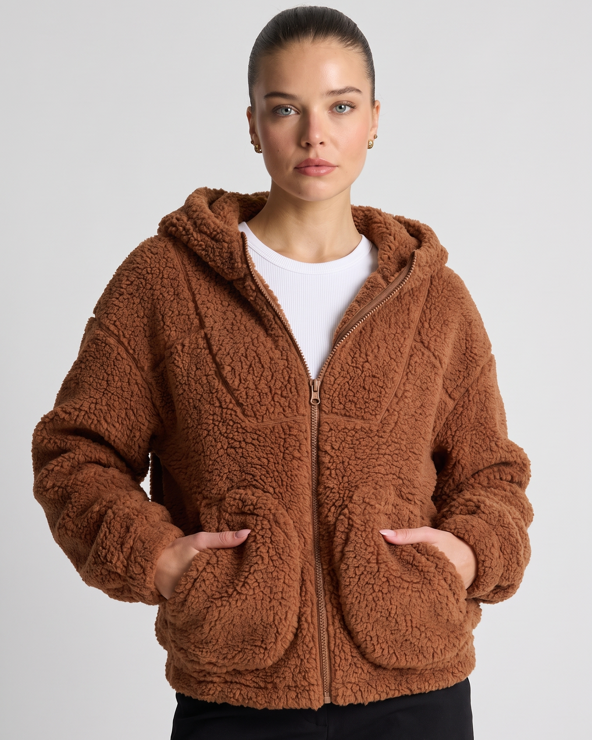 NOLA model wearing brown relaxed fit zip up jacket