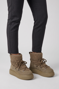 NOLA model wearing lace-up platform ankle boots
