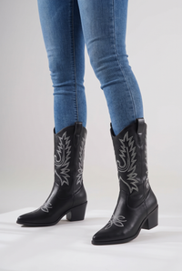 NOLA model wearing embroidered mid-calf cowboy boots black and white