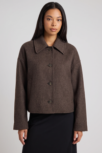 NOLA model wearing brown boxy cropped button-down jacket