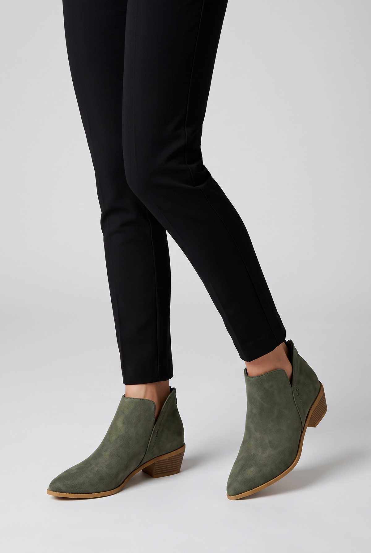 NOLA model wearing pointed toe ankle boots