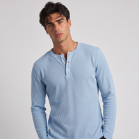 NOLA model wearing long sleeve henley shirt light blue