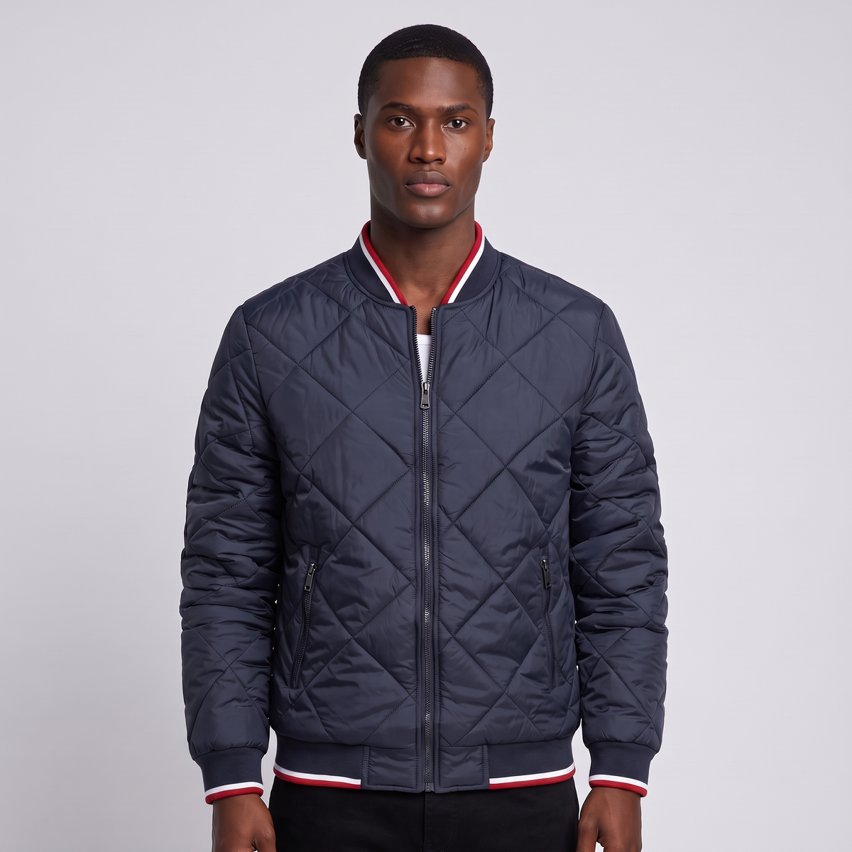 NOLA model wearing navy diamond quilted bomber jacket
