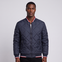 NOLA model wearing navy diamond quilted bomber jacket